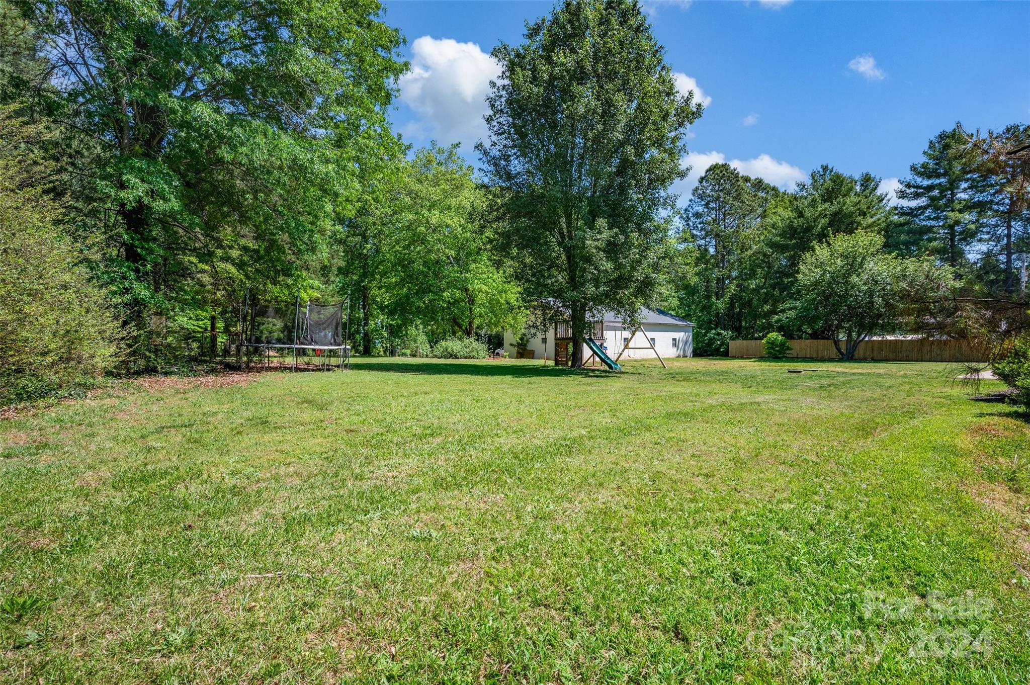 326 Gilbert Road Statesville, NC 28677 - Photo 24 of 25 a view of green field with trees in the background