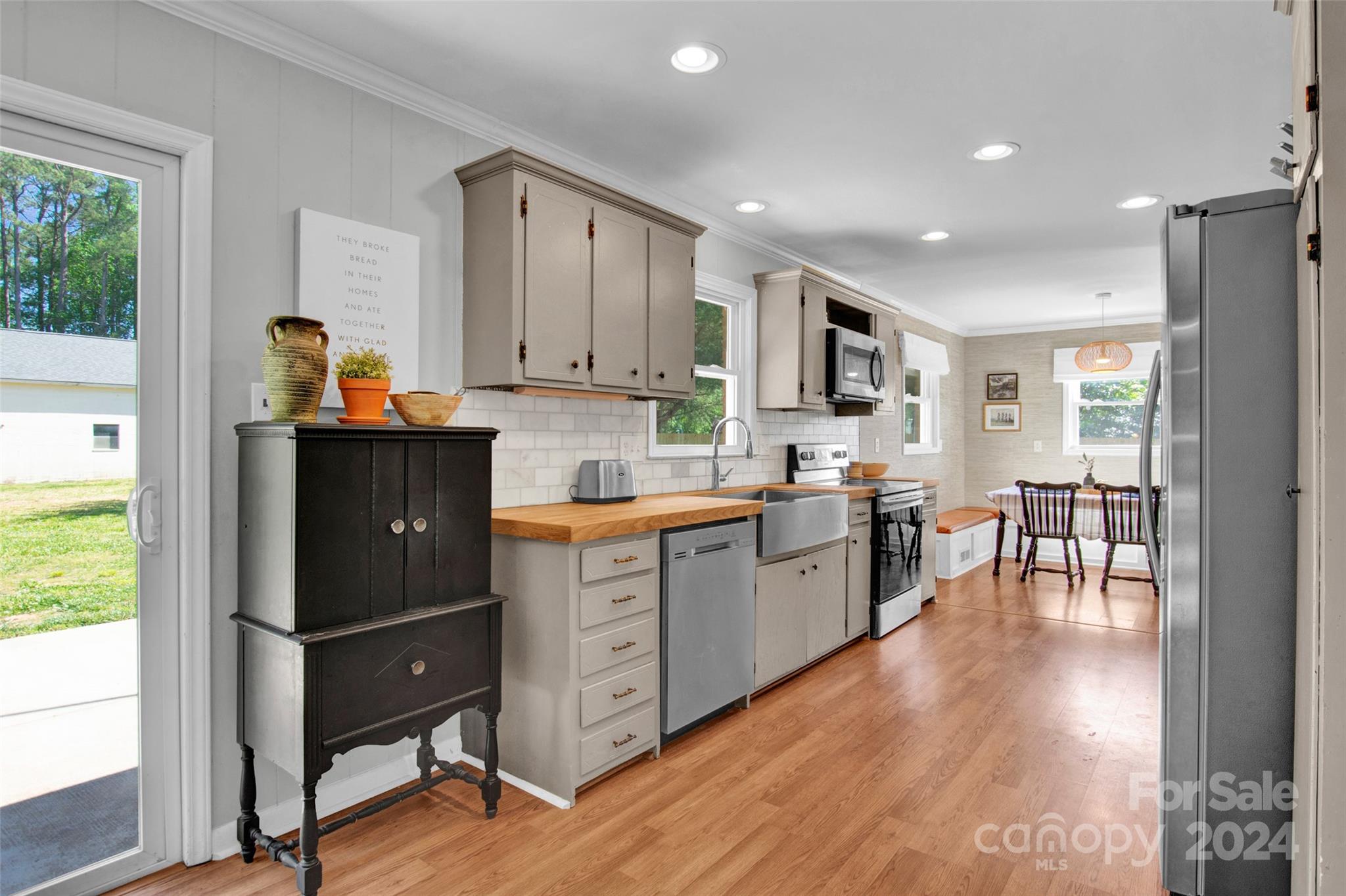 326 Gilbert Road Statesville, NC 28677 - Photo 9 of 25 a kitchen with granite countertop a stove a refrigerator and a dining table with wooden floor