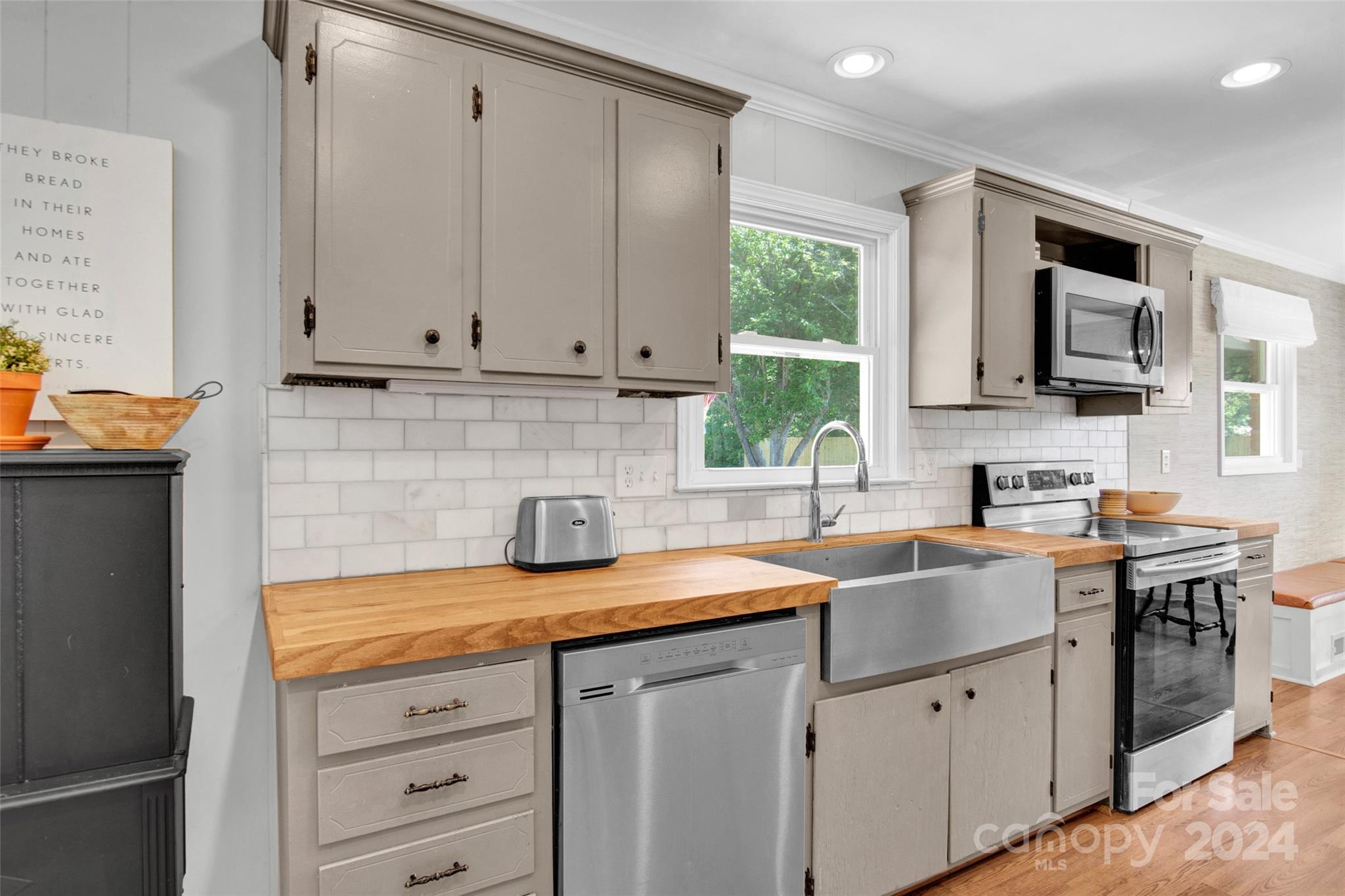 326 Gilbert Road Statesville, NC 28677 - Photo 10 of 25 a kitchen with stainless steel appliances granite countertop a sink stove and cabinets