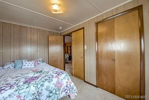 a bedroom with a bed and a mirror