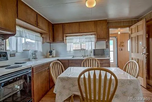 a kitchen with stainless steel appliances granite countertop a stove a sink dishwasher and cabinets