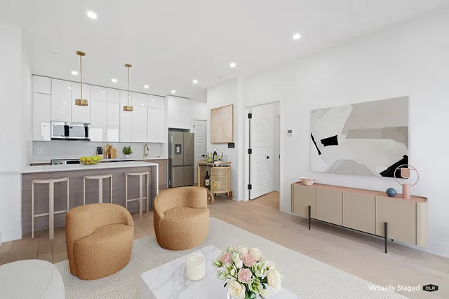 a living room with furniture and kitchen view