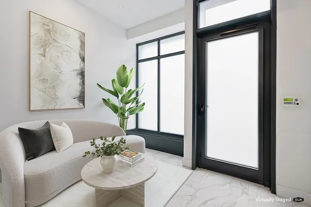 a living room with furniture and a potted plant