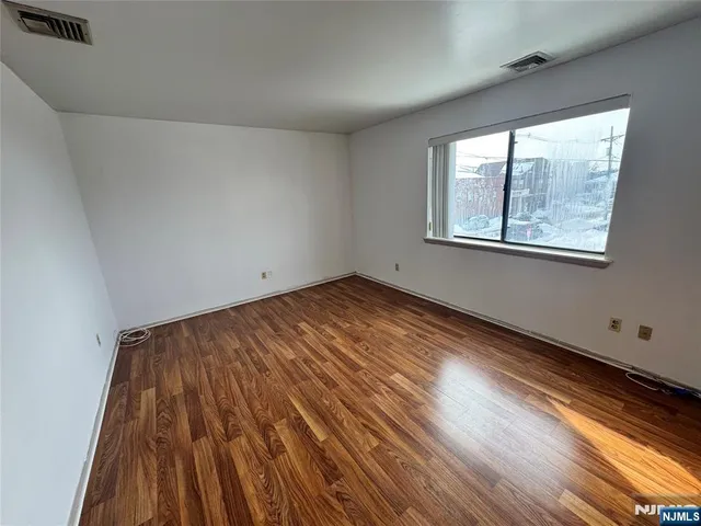 a view of a street with wooden fence