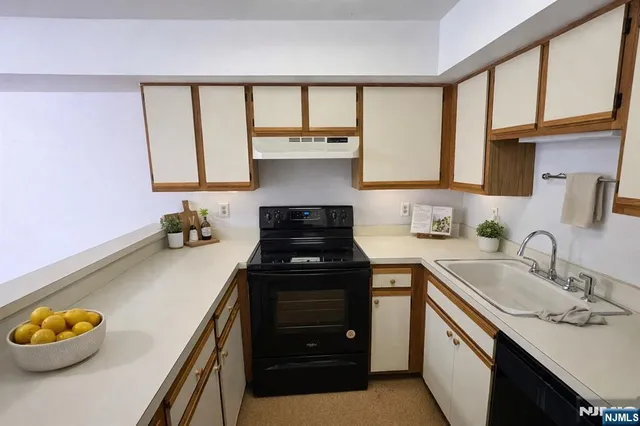 a kitchen with a sink cabinets and a stove
