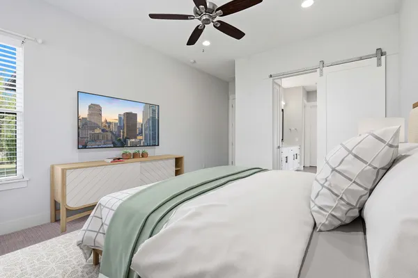 a bedroom with a bed and a chandelier