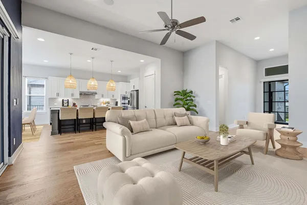 a living room with furniture and kitchen view