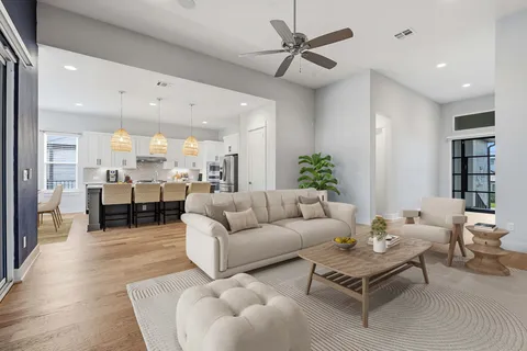 a living room with furniture and kitchen view
