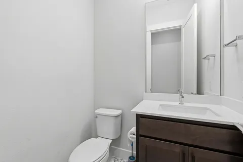 a bathroom with a sink a toilet and mirror