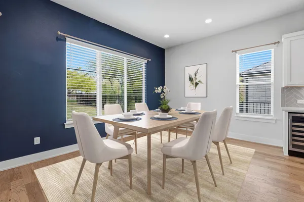 a view of a dining room with furniture and wooden floor