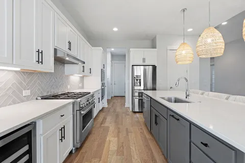 a large kitchen with cabinets and stainless steel appliances