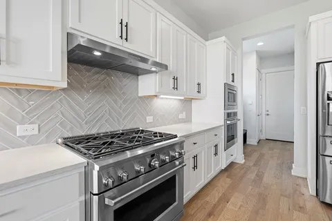 a kitchen with wooden cabinets and a stove top oven