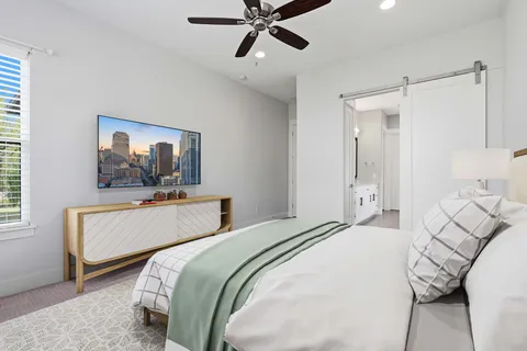 a bedroom with a bed and a chandelier