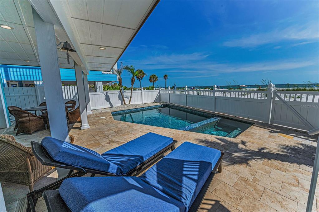 13303 Gulf Lane Madeira Beach, FL 33708 - Photo 34 of 42 a view of a balcony with table and chairs