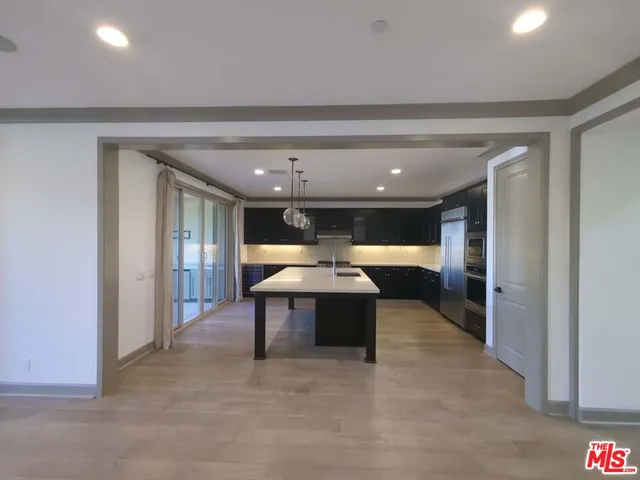 a kitchen with a sink a microwave and refrigerator