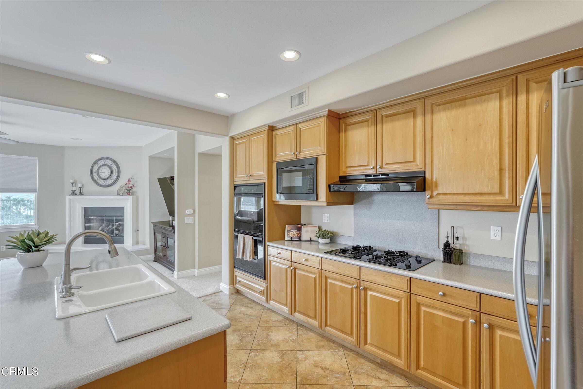 3315 Rising Star Avenue Simi Valley, CA 93063 - Photo 16 of 74 a kitchen with stainless steel appliances granite countertop a stove a sink and a refrigerator