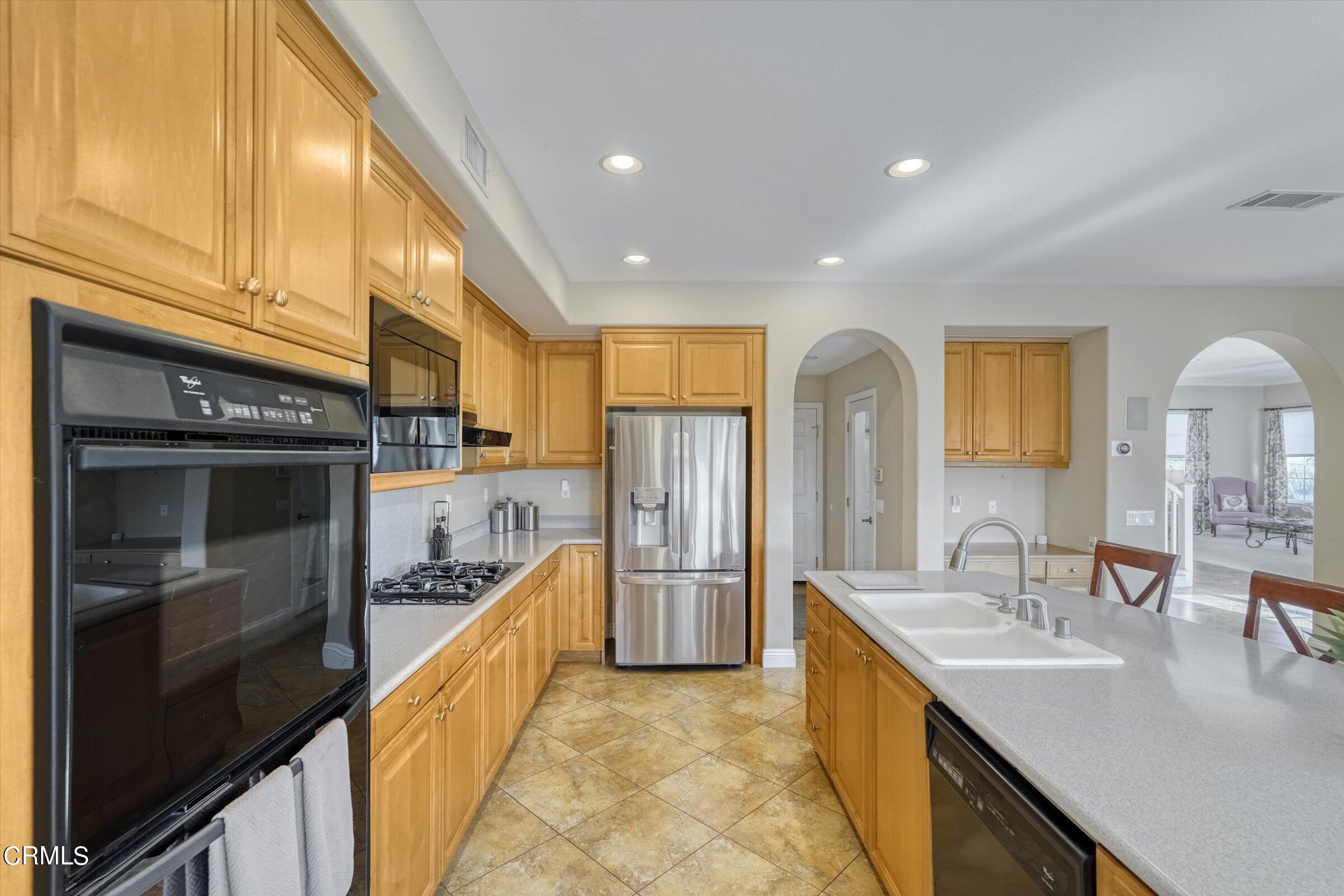 3315 Rising Star Avenue Simi Valley, CA 93063 - Photo 17 of 74 a large kitchen with stainless steel appliances granite countertop a sink and cabinets