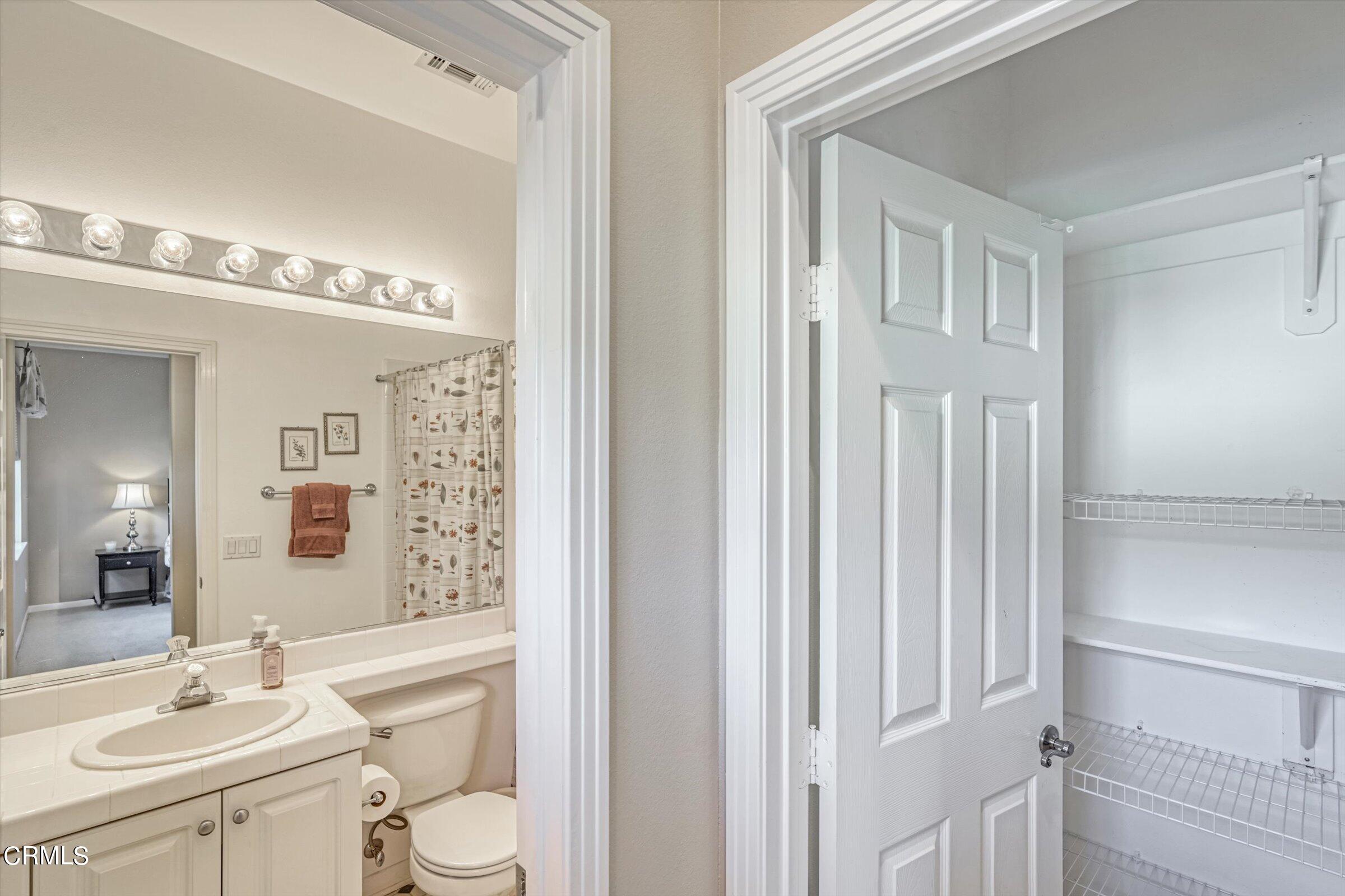 3315 Rising Star Avenue Simi Valley, CA 93063 - Photo 34 of 74 a bathroom with a sink vanity mirror and toilet