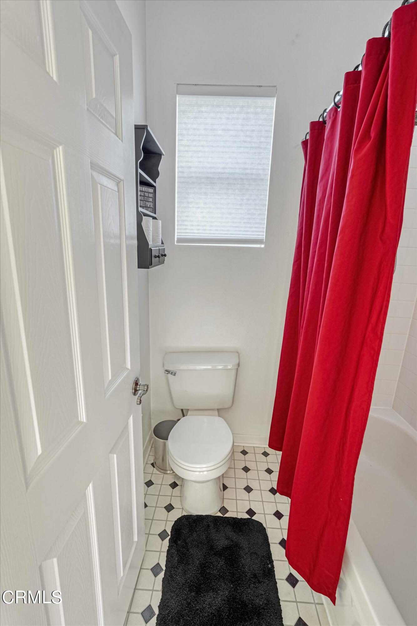 3315 Rising Star Avenue Simi Valley, CA 93063 - Photo 43 of 74 a bathroom with a toilet and a shower curtain