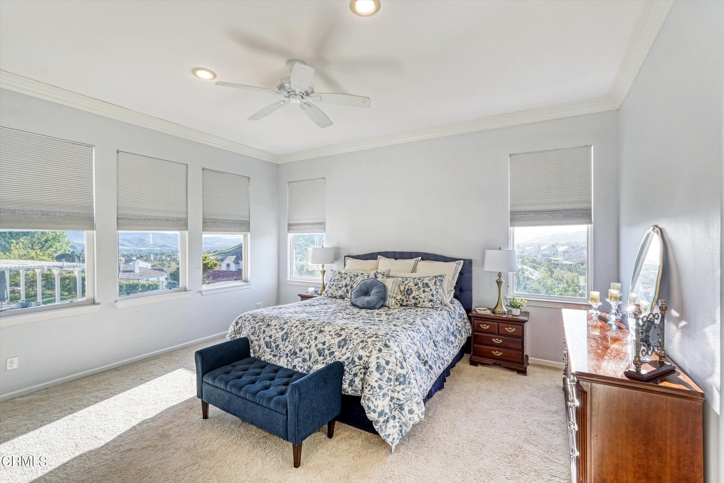 3315 Rising Star Avenue Simi Valley, CA 93063 - Photo 50 of 74 a bedroom with a large bed and a chandelier
