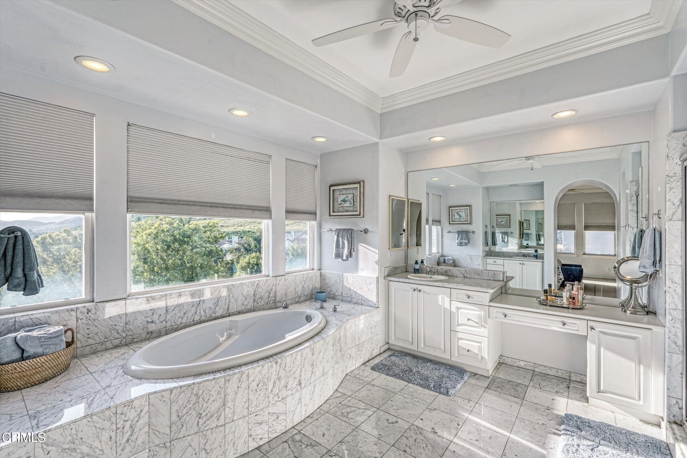 3315 Rising Star Avenue Simi Valley, CA 93063 - Photo 55 of 74 a large white kitchen with kitchen island a large window cabinets and stainless steel appliances