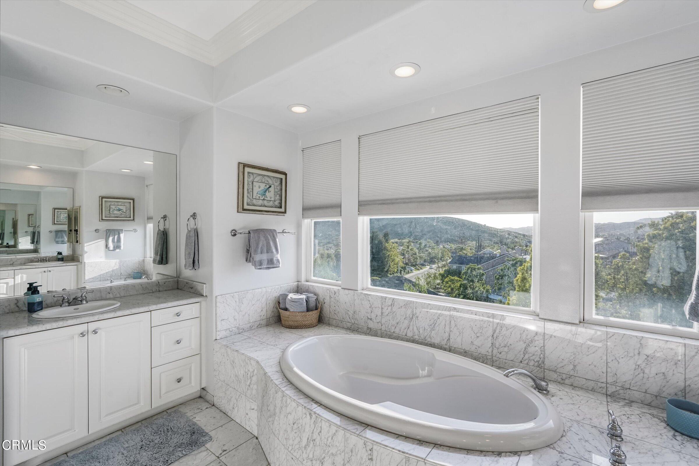 3315 Rising Star Avenue Simi Valley, CA 93063 - Photo 56 of 74 a spacious bathroom with a granite countertop tub sink and mirror