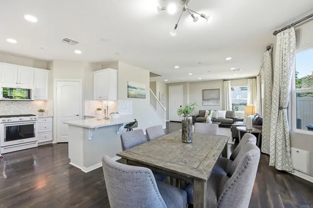 a large kitchen with a table chairs and a refrigerator