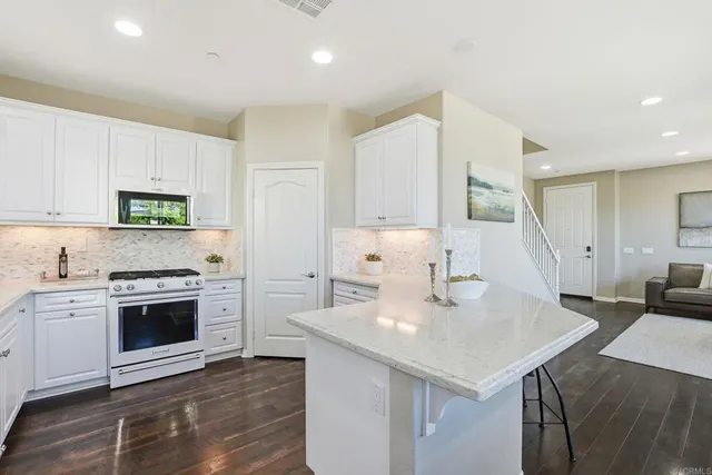 a kitchen with a sink a stove and cabinets