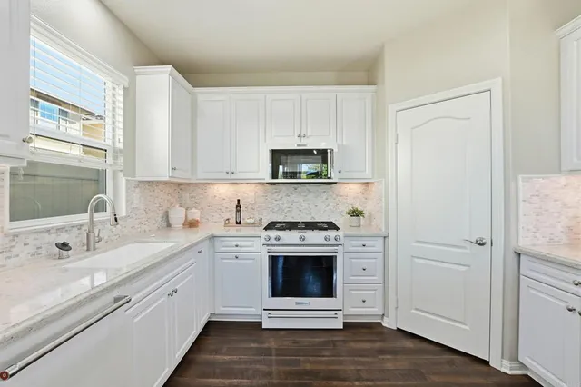 a kitchen with a stove oven and a sink