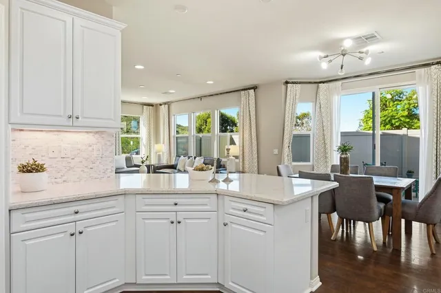 a kitchen with sink and view living room