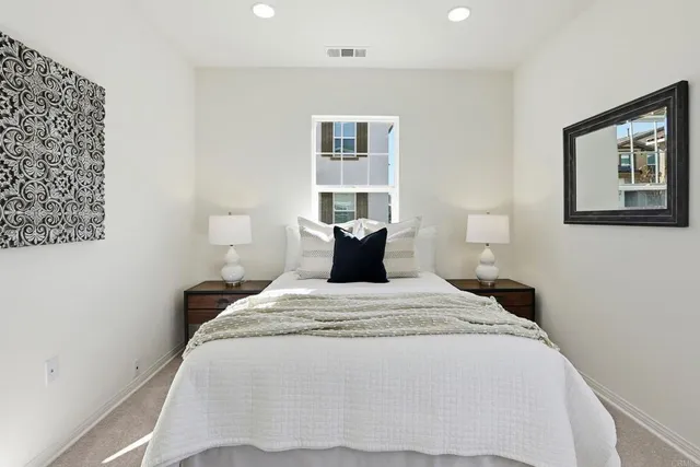 a bedroom with bed and window