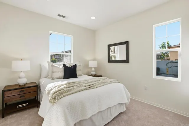 a bedroom with a bed and a night stand