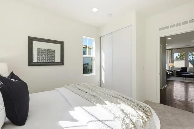 a bedroom with a large bed and a chandelier