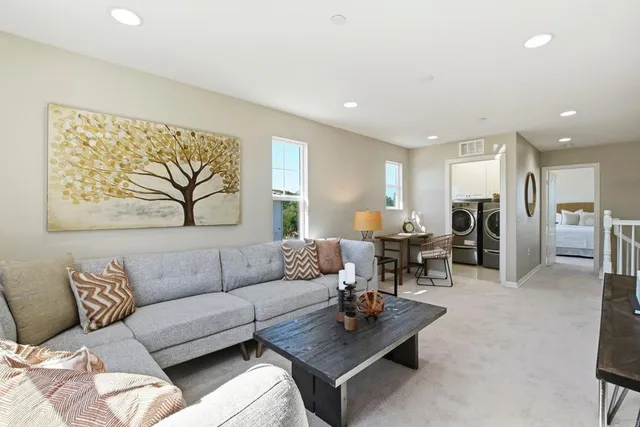 a living room with furniture and kitchen view