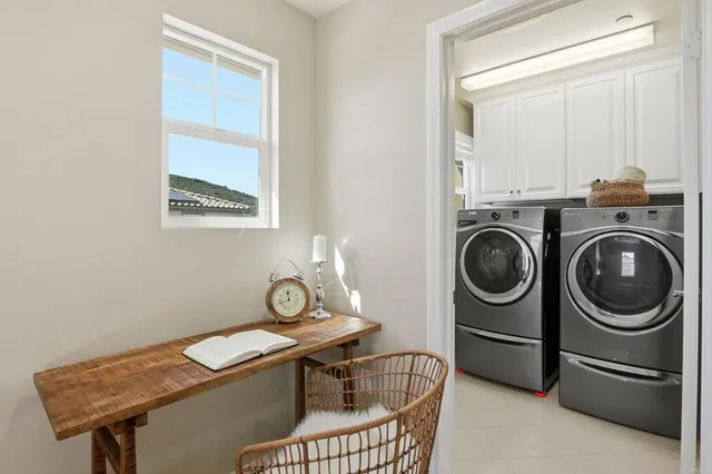 a view of a storage and utility room with washer and dryer
