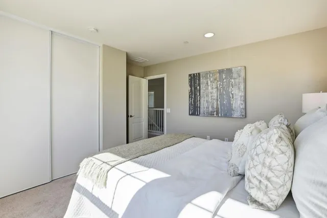 a bedroom with a large bed and a window