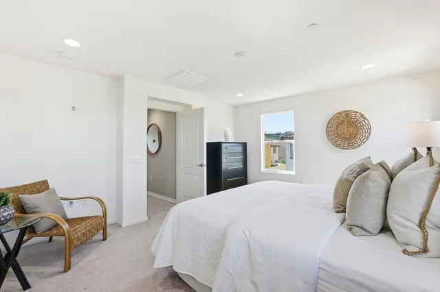 a bedroom with a bed and painting on the wall