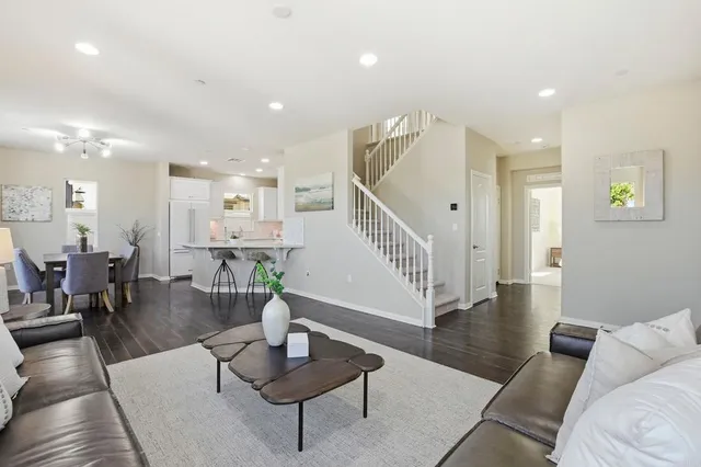 a living room with furniture and wooden floor