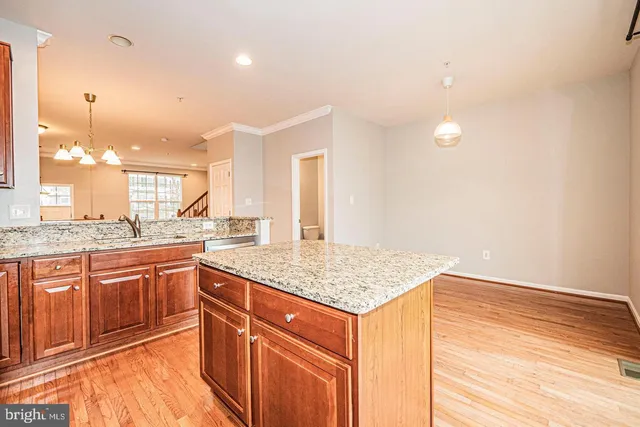 a kitchen that has a sink and a wooden floor