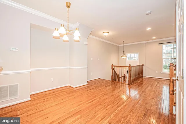 a view of a dining room with furniture and a chandelier