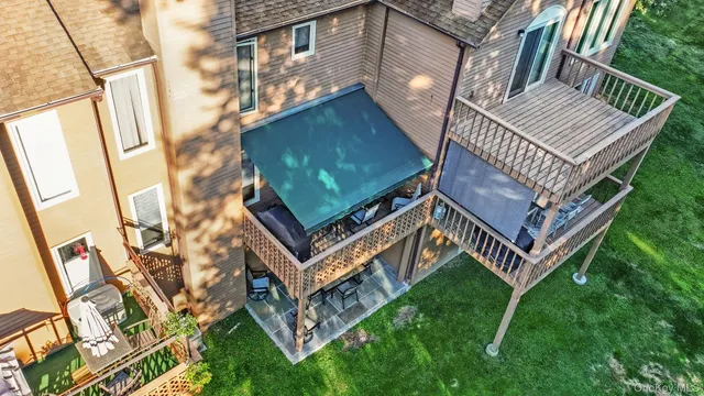 a view of a house with a yard and deck