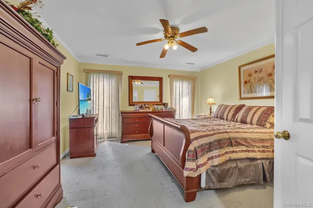 a spacious bedroom with a bed and a chandelier