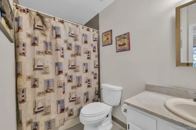 a white toilet sitting next to a bathroom sink