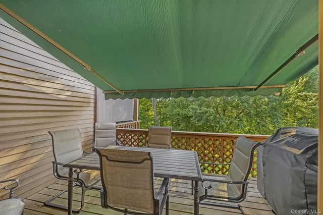 a view of a chairs and table in the balcony
