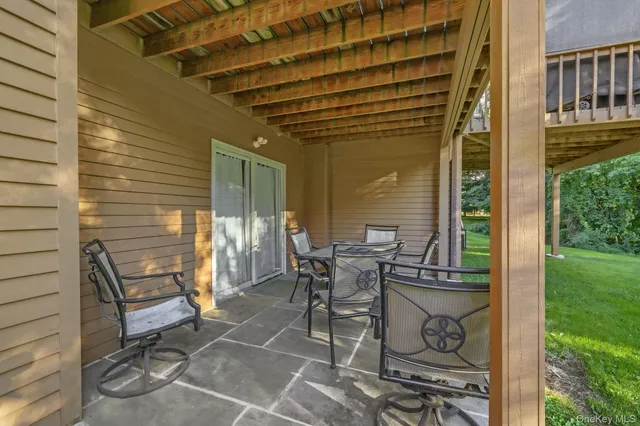 a view of a patio with table and chairs and potted plants