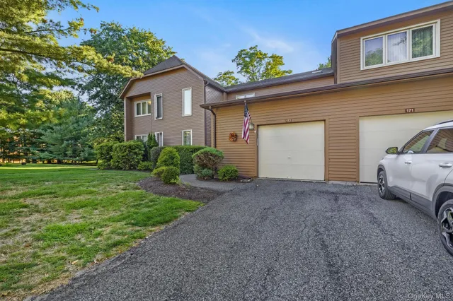 a view of a house with a backyard