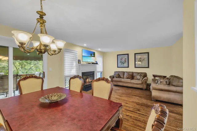 a living room with furniture chandelier and a table