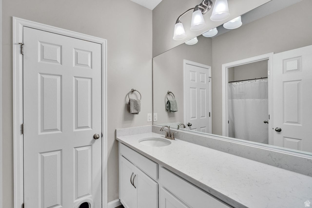 3269 West 650 North Layton, UT 84041 - Photo 25 of 35 Bathroom vanity featuring an integrated sink, brushed nickel faucet, and a light-toned countertop