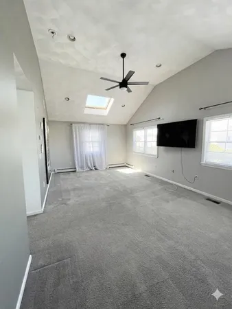 a view of an empty room with kitchen