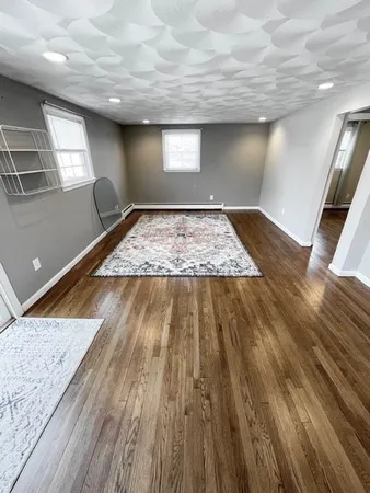a view of a livingroom with a ceiling fan and window